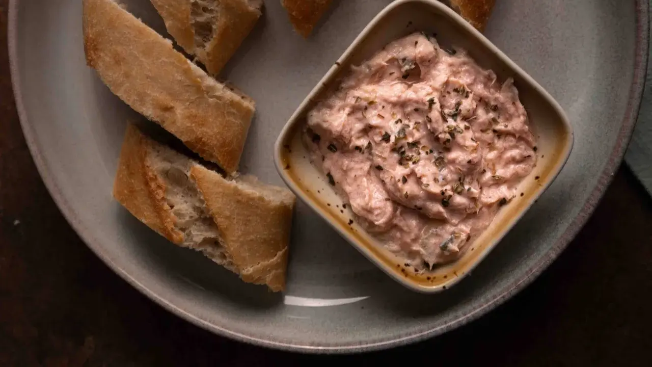 Cremige Thunfischcreme, italienisch gewürzt, mit knusprigem Baguette auf einem Teller. Ein Genuss für jeden Gaumen.