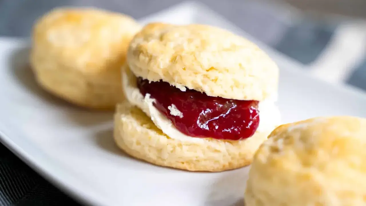 Frisch gebackene Scones mit Clotted Cream und Erdbeermarmelade. Ein perfektes Scones Rezept für den Nachmittagstee.