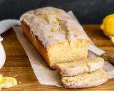 Saftiger veganer Zitronenkuchen mit Zuckerguss und Zitronenschale bestreut. Ein köstlicher Genuss!
