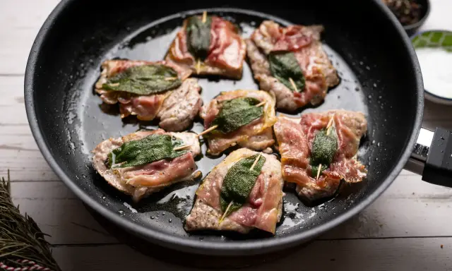 Saltimbocca alla romana in einer Pfanne, mit Salbei und Parmaschinken umwickelt.